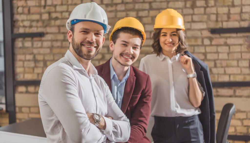 team of happy architects in hard hats looking at c 2021 08 30 19 53 11 utc 1
